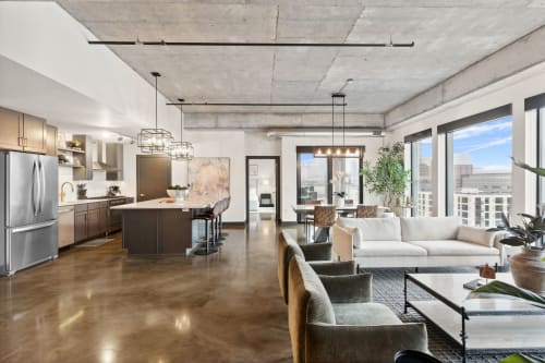 Stylish open-concept living area with modern kitchen and city views.