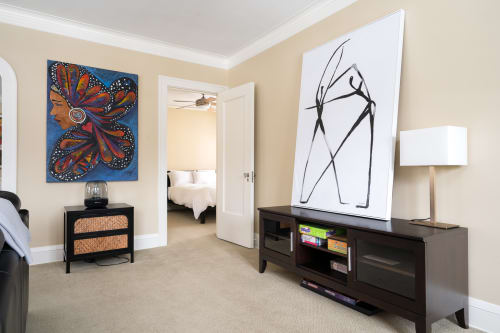 A vibrant living area featuring colorful artwork and modern furnishings.
