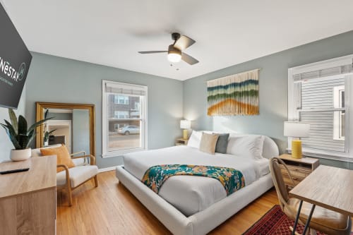 A modern and inviting bedroom with stylish decor and comfortable amenities.