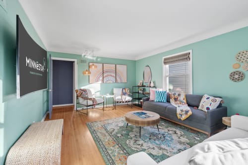 A chic and welcoming living room with mint green walls and stylish decor.