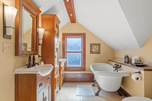 Elegant vintage bathroom with a freestanding tub and dual sink vanity.