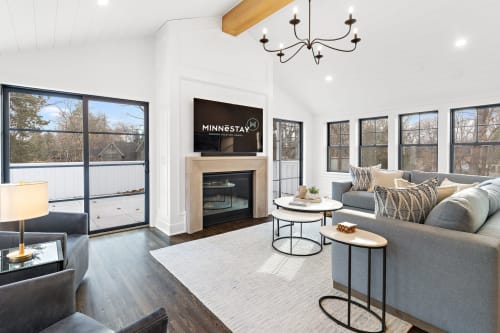 A bright and modern living room featuring comfortable seating and stylish decor.