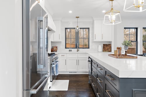 A modern kitchen featuring a spacious island and stylish navy blue cabinetry.