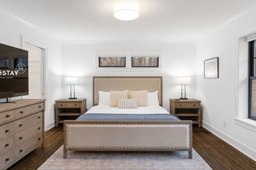 A modern and elegantly furnished bedroom with a cozy atmosphere.