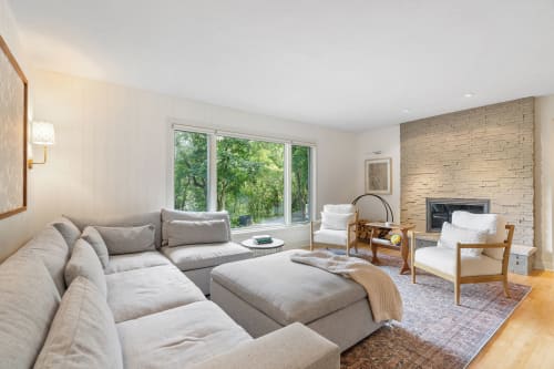 A modern living room with cozy seating and natural light.