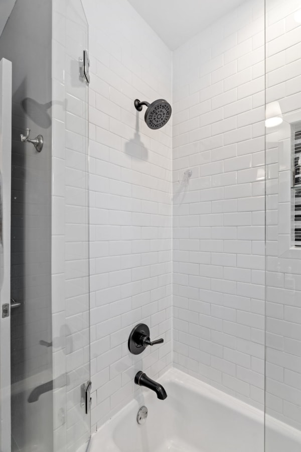 Modern shower with white tiles and black fixtures