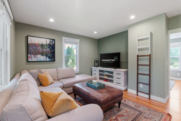 Cozy living room featuring a sectional sofa, modern art, and a television.