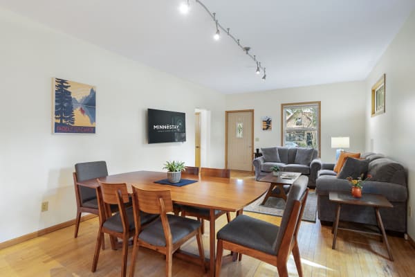 Inviting living area with dining table, sofa, and decorative elements.