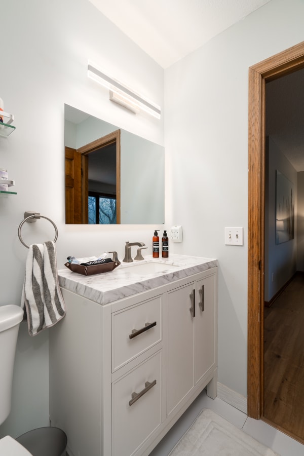 Contemporary bathroom featuring a marble countertop and modern amenities.