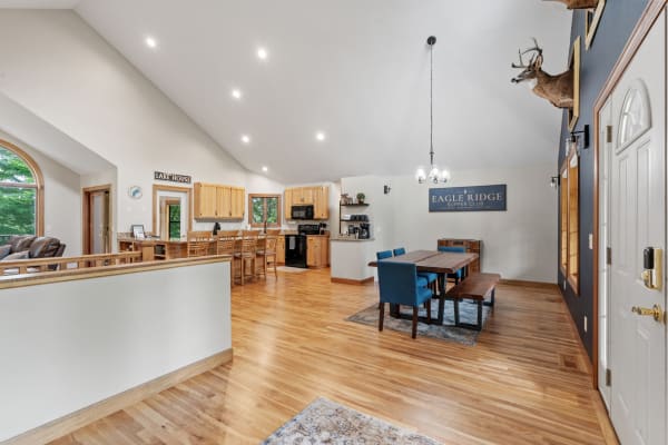 Interior view of a contemporary home showcasing a living area, kitchen, and dining area with rustic decor.