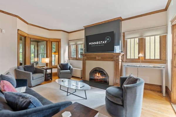 Cozy living room with modern decor and fireplace.