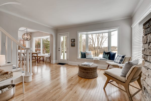 Bright living room with bay window and cozy seating area.