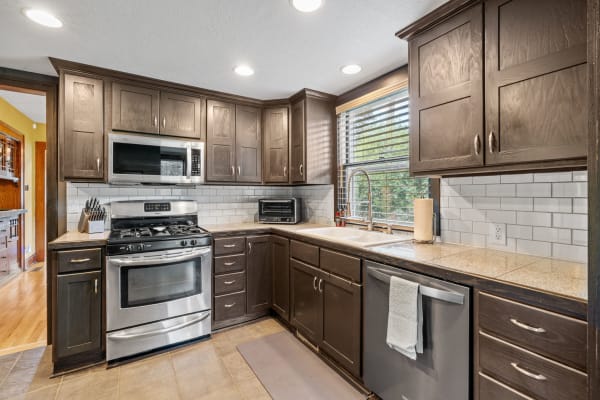 Modern kitchen with dark cabinets and stainless steel appliances