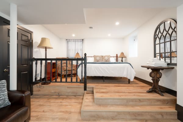 Comfortable and well-lit basement bedroom with modern furnishings.