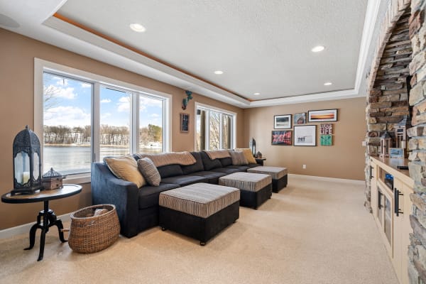Bright living room with large windows, a sectional sofa, and decorative elements.
