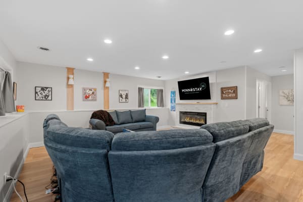 Cozy modern living room featuring a blue sectional sofa and contemporary fireplace.