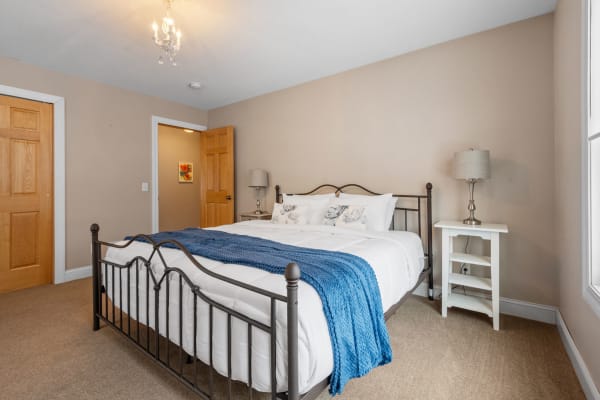 A cozy bedroom with a stylish bed and decorative details.