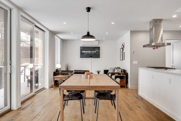Interior view of a modern kitchen and dining area with a large window.