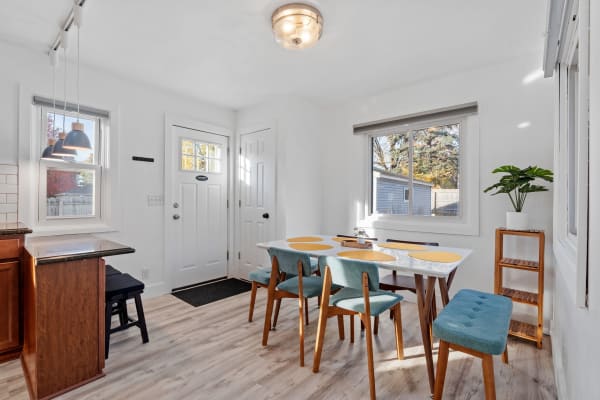 Bright dining area with wooden furniture and blue seating.