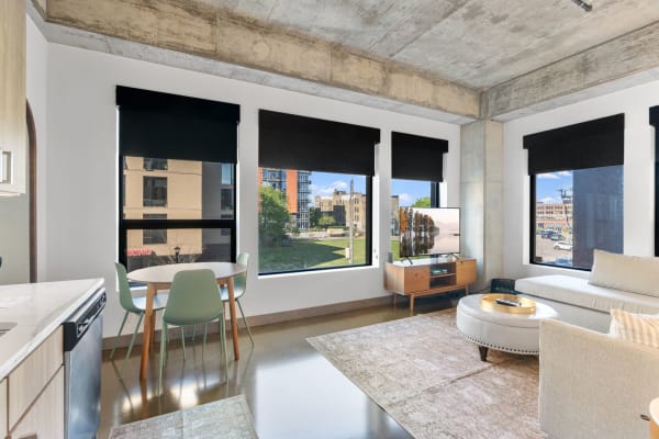 Modern living room with large windows and sleek decor.