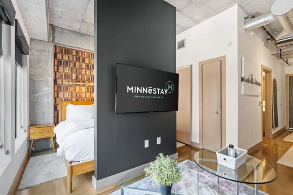 Modern vacation rental interior with a cozy bed and stylish design elements.