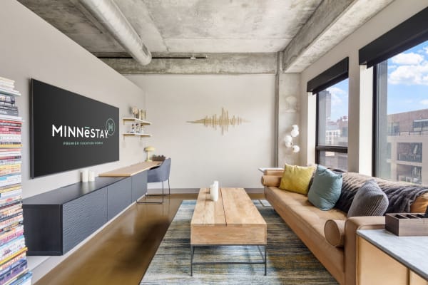 Modern living room featuring a leather sofa, a wooden coffee table, and a sleek entertainment unit.