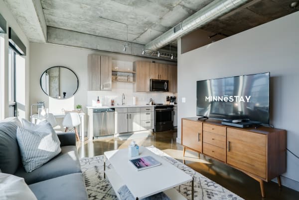Modern studio apartment with open kitchen and living area.