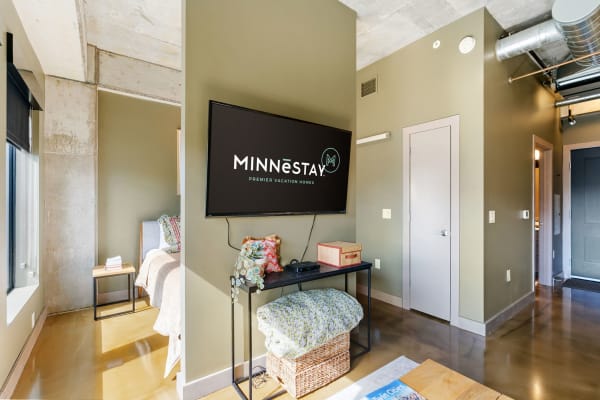 Interior view of a modern vacation home with a wall-mounted TV and minimalist furniture.