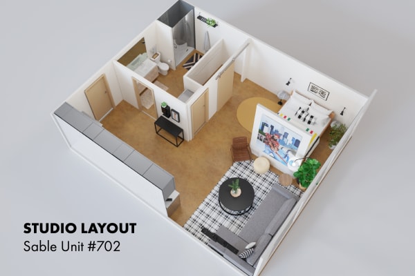 Top-down view of a studio apartment layout with living area, kitchen, and bathroom.