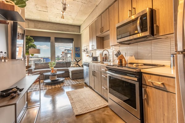 Cozy modern kitchen and living room with city skyline view.
