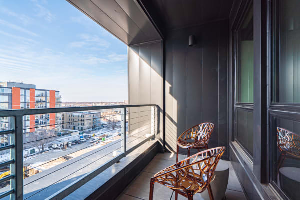 Modern balcony with chairs and a view of the city.