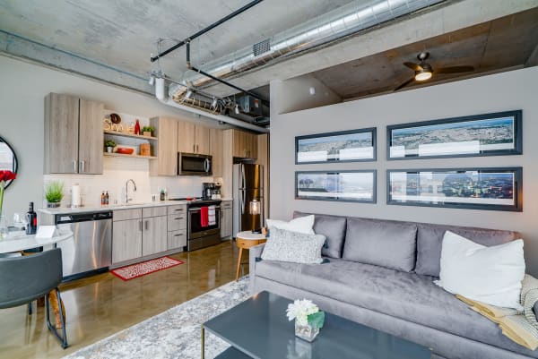 Stylish modern apartment interior featuring a kitchen and living area with industrial decor.