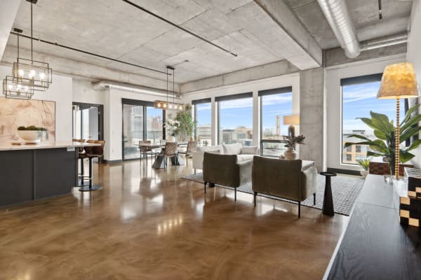 A modern loft interior with large windows and contemporary furnishings.