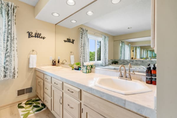 Modern bathroom with a sleek vanity, a sink, and decorative elements.