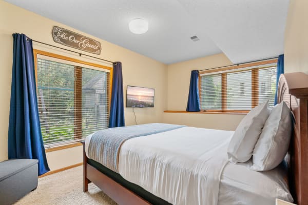 Cozy bedroom with a bed, TV, and inviting decor.