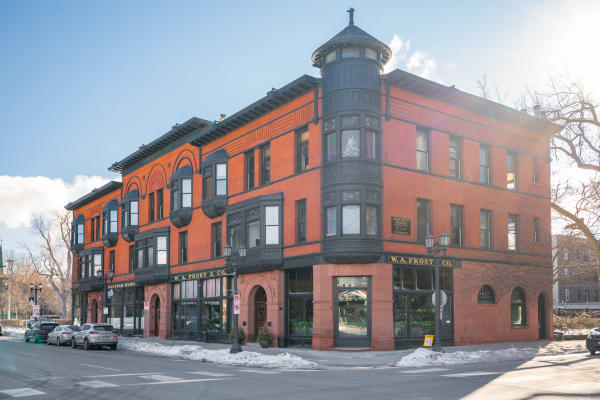 Corner building with red brick facade and black decorative elements, featuring W.A. Frost & Co. sign.