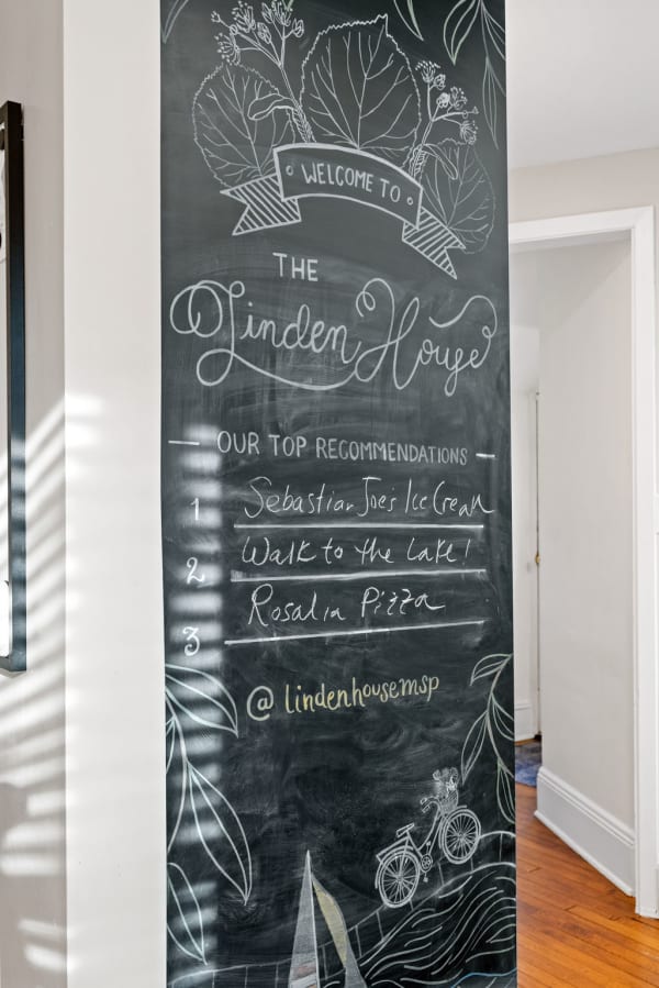 A chalkboard displaying welcome message and recommendations at The Linden House.