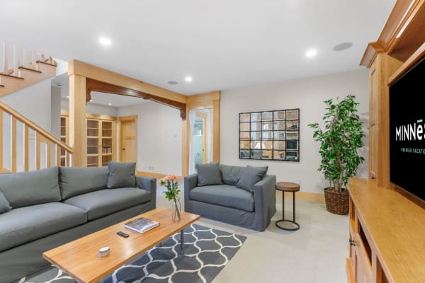 Warm and inviting living room with gray couches and a wooden coffee table.