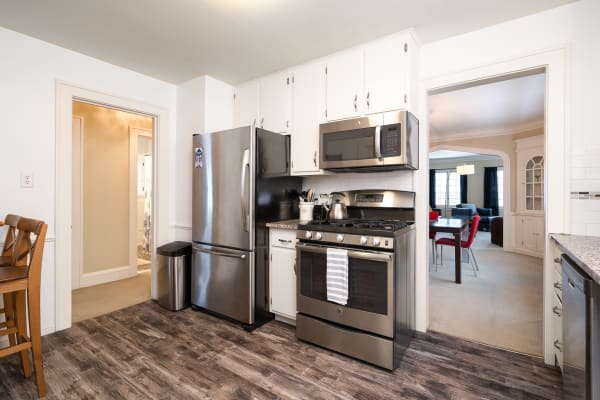 Modern kitchen showcasing stainless steel appliances and a view into a adjacent living space.
