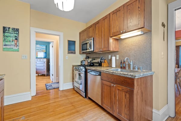 Interior of a kitchen featuring wooden cabinets and modern appliances.