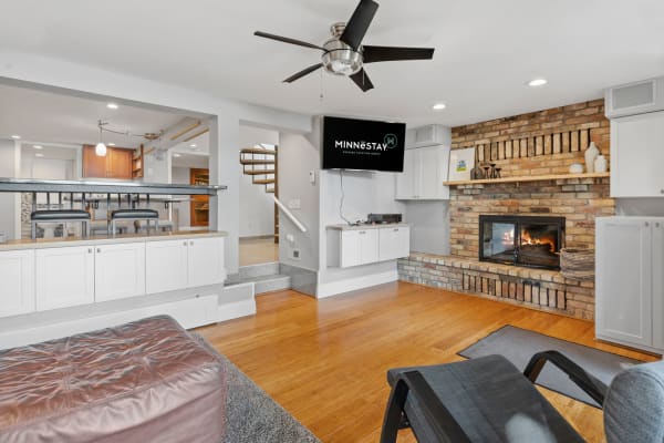 Modern living room featuring a fireplace, flat-screen TV, and stylish furnishings.