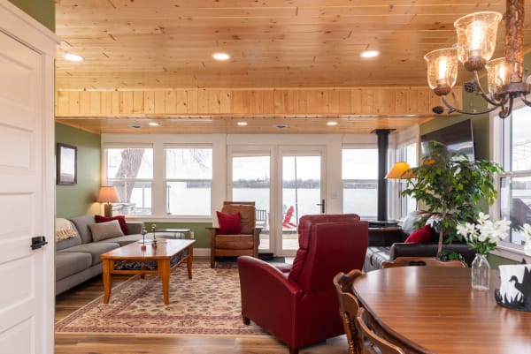 A cozy living room featuring wooden elements and views of a lake.