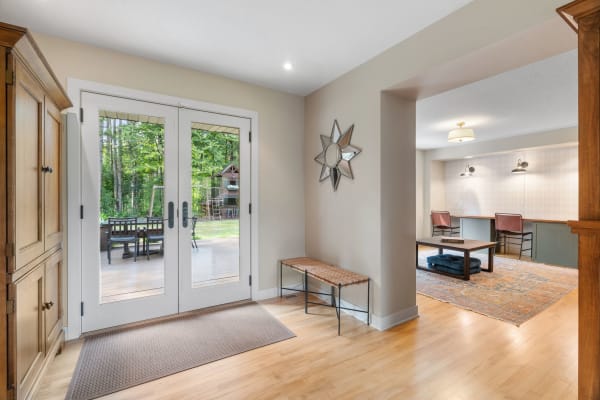 A bright entryway with double doors and a rustic interior decor.