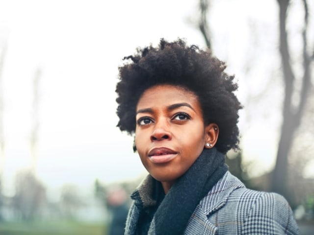 A young woman gazing thoughtfully into the distance