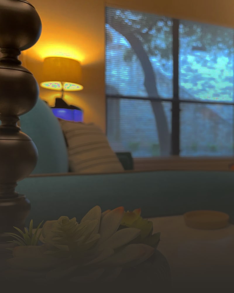A therapy room at the Austin office with a blue couch and boat-shaped bookshelf