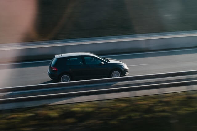 black vehicle speeding on the street