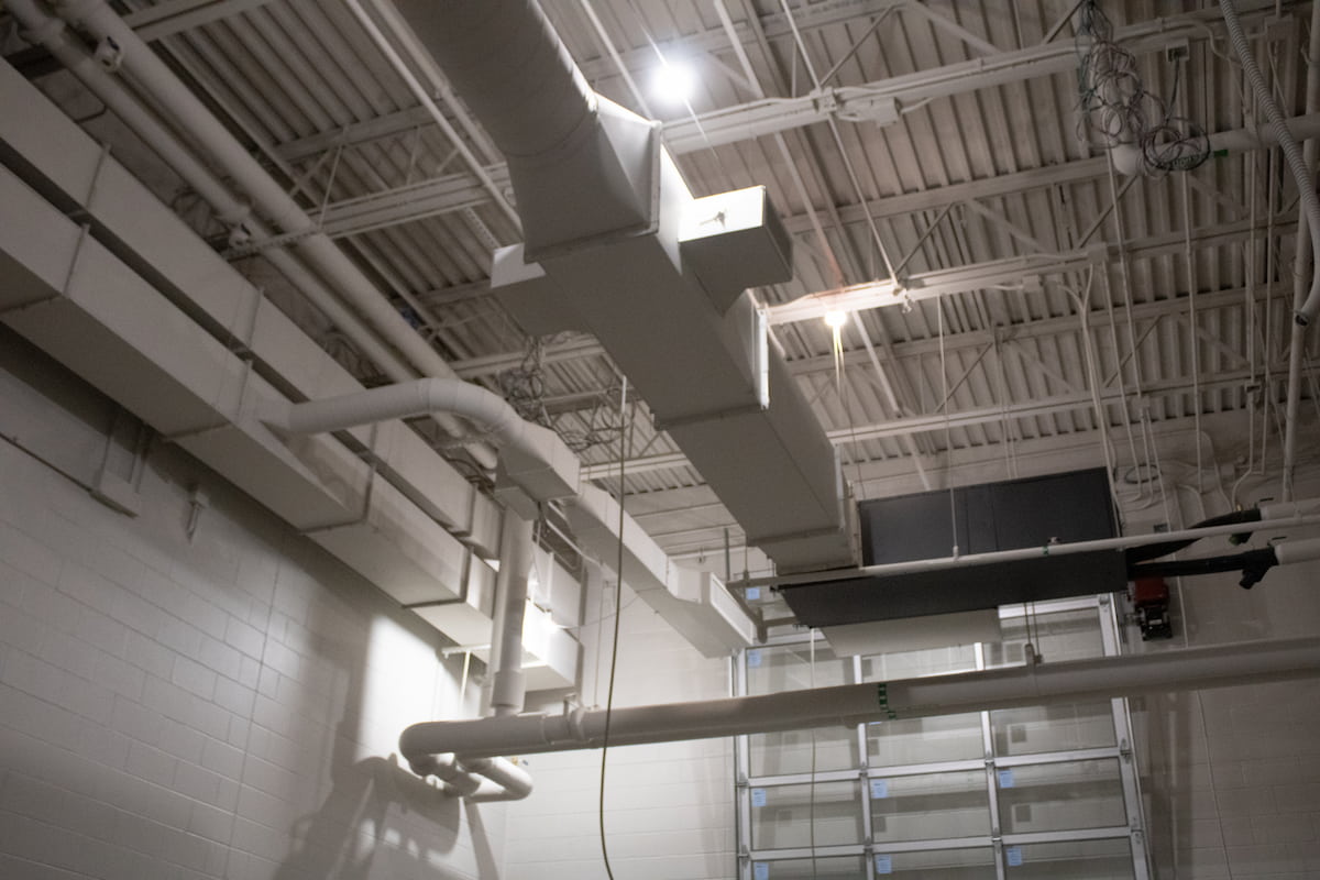 white hvac duct work and piping on celing