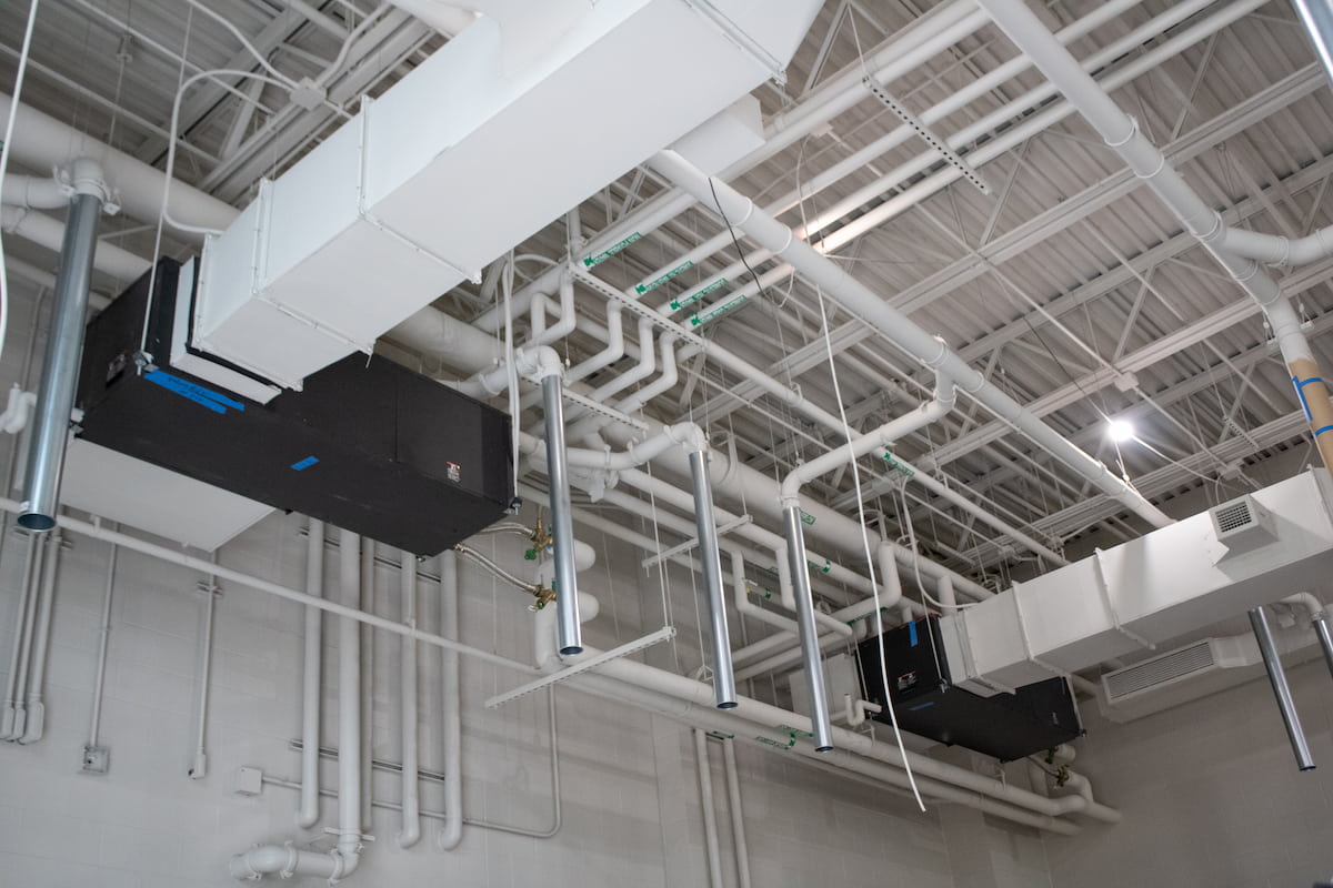 white HVAC duct work and piping on celing