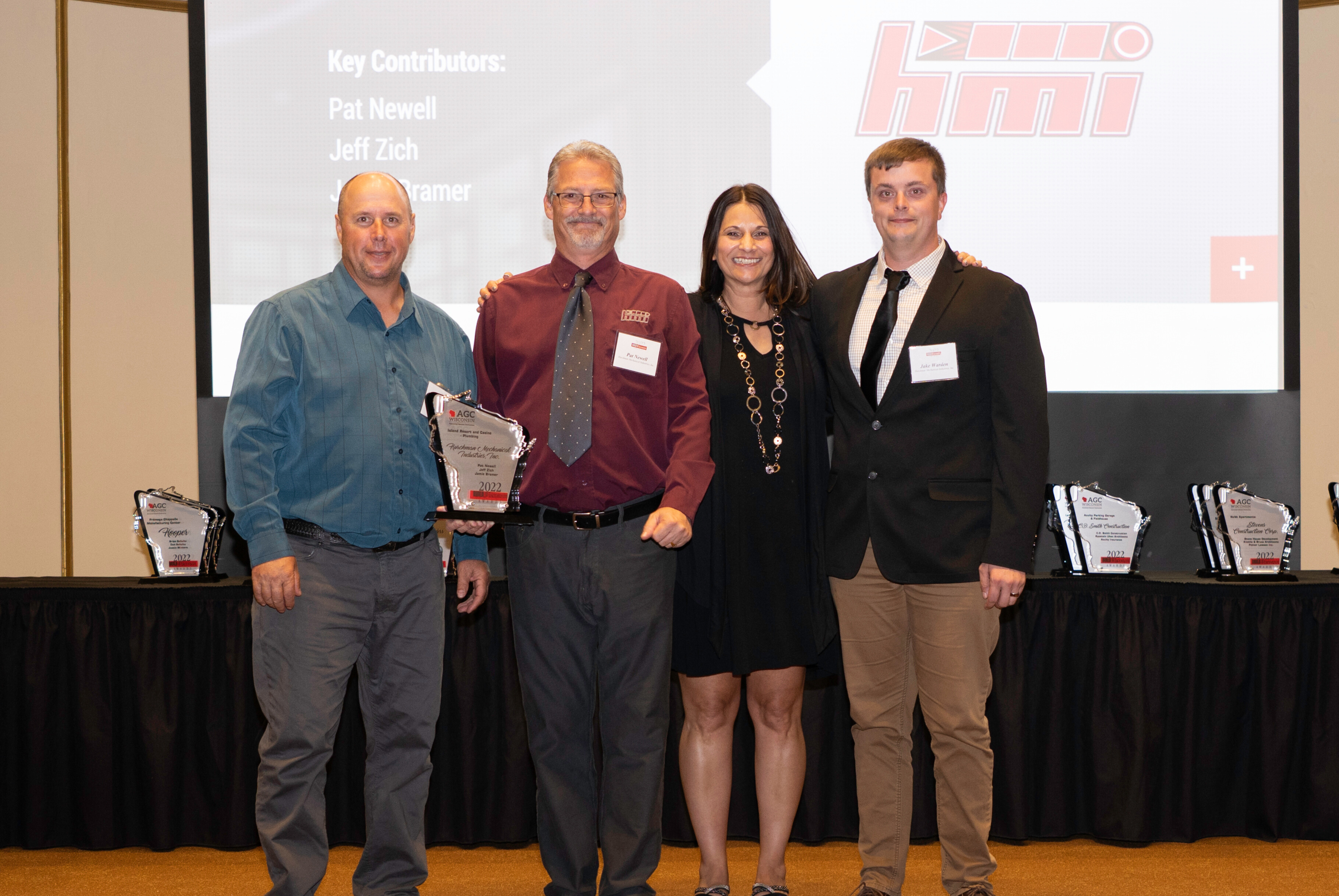 group picture of four hurckman team members accepting the agc build wisconsin award in 2022 for excellence in commercial plumbing