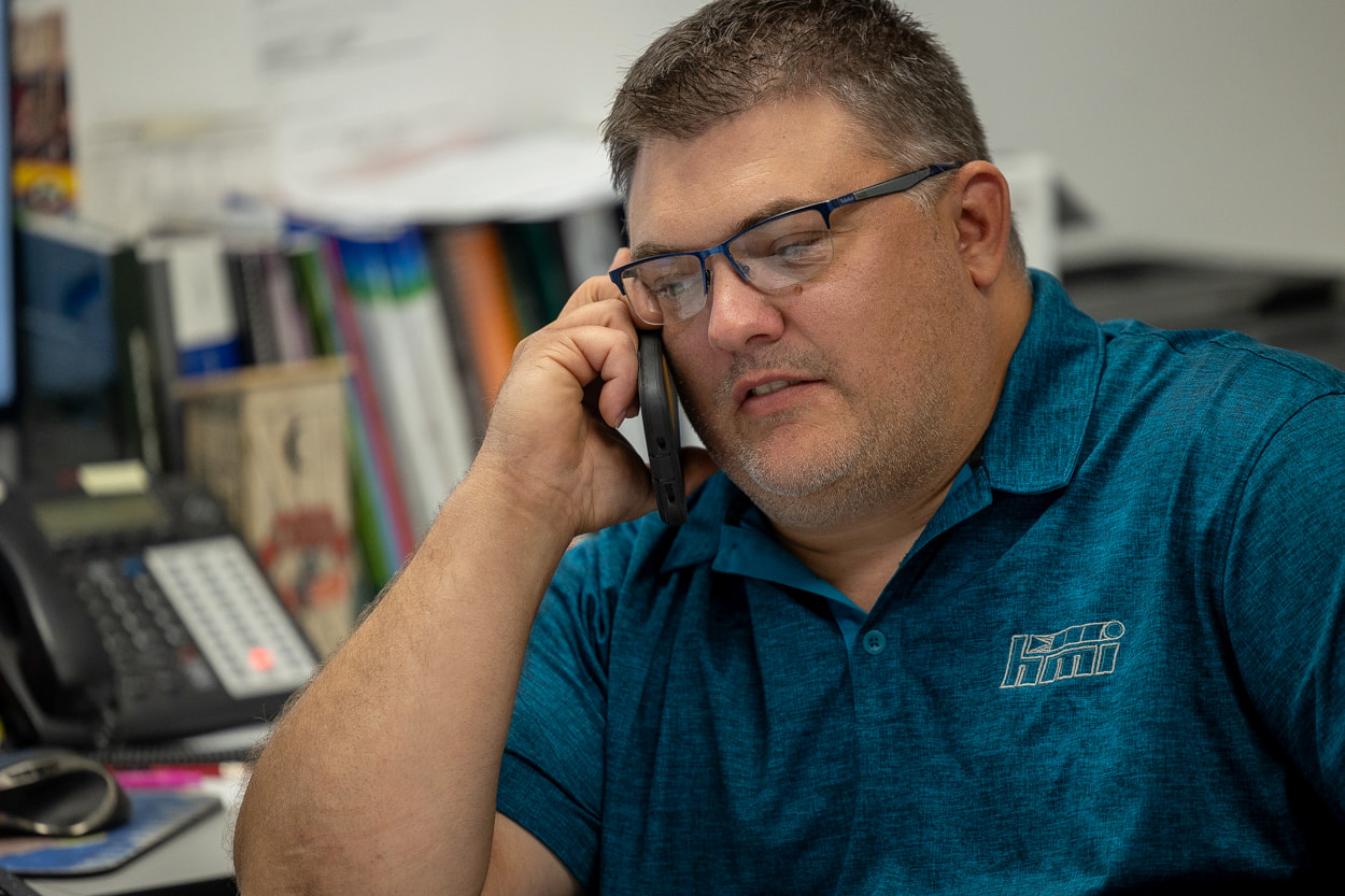 Dave Demmin on the phone at his desk